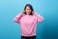 Portrait of angry young woman covering her ears, stop making that loud noise giving me a headache Royalty Free Stock Photo