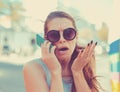 Portrait angry young woman screaming on mobile phone standing outside with city background. Negative emotions feelings Royalty Free Stock Photo