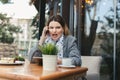 Portrait of angry young woman solving business problems shouting during phone conversation sitting in cafe terrace Royalty Free Stock Photo