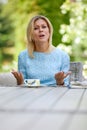 Portrait of angry young woman solving business problems sitting in modern coffee shop. pretty young woman enjoying free Royalty Free Stock Photo