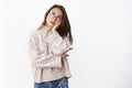 Portrait of annoyed and bored young woman in glasses and sweater leaning palm on face rolling eyes up from irritation