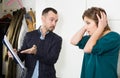 Annoyed debt collector and shocked woman Royalty Free Stock Photo
