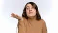 Portrait of annoyed and strssed woman making wtf hand gesture over white studio background Royalty Free Stock Photo