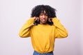 Portrait annoyed, unhappy, stressed african woman covering her ears, looking up stop making loud noise isolated on white