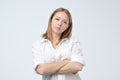 Portrait of annoyed woman with arms folded, isolated studio photo on white background.