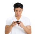 portrait of an anxious young man looking at phone seeing bad news Royalty Free Stock Photo