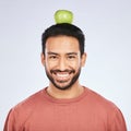 Portrait, apple head balance and man smile for weight loss diet, healthy snack or body nutrition vitamins. Eating food Royalty Free Stock Photo