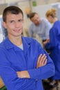 Portrait apprentice engineer posing crossing arms in laboratory