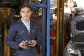 Portrait Of Apprentice Mechanic In Auto Repair Shop