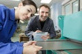 Portrait apprentice working with engineer on cnc machine Royalty Free Stock Photo