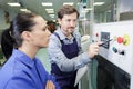 portrait apprentice working with engineer on cnc machine Royalty Free Stock Photo