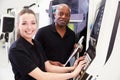 Portrait Of Apprentice Working With Engineer On CNC Machine Royalty Free Stock Photo