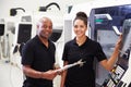 Portrait Of Apprentice Working With Engineer On CNC Machine Royalty Free Stock Photo