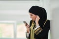 Portrait of Arab woman in traditional clothes using mobile phone Royalty Free Stock Photo