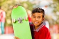 Portrait of Arabian boy with green skateboard Royalty Free Stock Photo