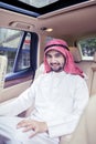 Arabian man smiling at the camera inside car Royalty Free Stock Photo