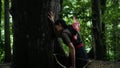 Portrait of archery woman walking fearlessly when seeing something and bravely in the jungle