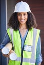 Portrait, architect and blueprint with a black woman designer wearing a reflective vest and hardhat for construction Royalty Free Stock Photo