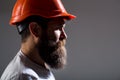 Portrait architect builder, civil engineer working. Builder in hard hat, foreman or repairman in the helmet. Bearded man