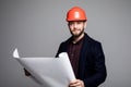 Portrait of an architect builder studying layout plan of the rooms, serious civil engineer working with documents on construction Royalty Free Stock Photo