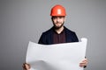 Portrait of an architect builder studying layout plan of the rooms, serious civil engineer working with documents on construction Royalty Free Stock Photo