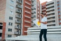 Portrait of an architect builder studying layout plan of the rooms, serious civil engineer working with documents on construction Royalty Free Stock Photo