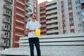 Portrait of an architect builder studying layout plan of the rooms, serious civil engineer working with documents on construction Royalty Free Stock Photo