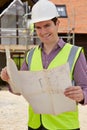 Portrait Of Architect On Building Site Looking At House Plans Royalty Free Stock Photo