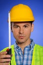 Portrait of architect in hardhat holding tape measure