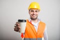 Portrait of architect offering takeaway coffee cup