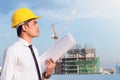 Portrait of architect wear yellow helmet safty on construction site with crane background Royalty Free Stock Photo