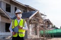 Portrait of Architect wearing a mask hold a laptop on a building construction site, Homebuilding Ideas and Prevention of Royalty Free Stock Photo