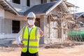 Portrait of Architect wearing a mask reassure on a building construction site, Homebuilding Ideas and Prevention of Coronavirus