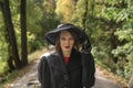 Portrait of aristocratic woman in black hat with veil, an autumn park. Middle-aged woman in vintage clothes, retro style Royalty Free Stock Photo