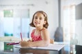 Portrait of the artist as a young girl. a little girl colouring in with coloured pencils. Royalty Free Stock Photo