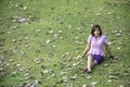 Portrait Asean woman sitting on the lawn in a park