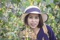 Portrait of Asean woman wearing a hat in the flower garden Royalty Free Stock Photo