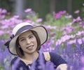 Portrait of Asean woman wearing a hat in the flower garden Royalty Free Stock Photo