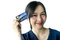 Portrait Asia smiling woman with credit card in hand,happy to have money concept