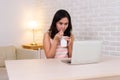 Portrait asia woman busy business eating yummy hot and spicy instant noodle over work looking tablet labtop