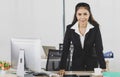 Portrait asian adult woman is office people wearing suit standing and putting her 2 hands put on work desk looking at camera look Royalty Free Stock Photo