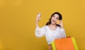 Portrait Asian beautiful happy young woman smiling cheerful and she is holding credit card and using smart phone for shopping Royalty Free Stock Photo