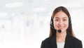 Portrait of Asian beautiful smiling woman customer support phone operator in office space banner background and copy space.Concept Royalty Free Stock Photo