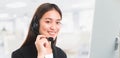 Portrait of Asian beautiful smiling woman customer support phone operator in office space banner background and copy space.Concept Royalty Free Stock Photo