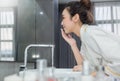 Portrait of asian beautiful woman cleansing face in the morning before shower. Royalty Free Stock Photo