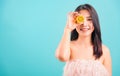 Portrait asian beautiful woman smiling her holding halves of orange on face near eyes Royalty Free Stock Photo