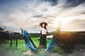 Asian Beautiful woman in Thai local dress standing and working with fishing net in fishing village with field and lake Royalty Free Stock Photo