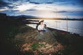 Asian Beautiful woman in Thai local dress working with fishing net in fishing village with field and lake background Royalty Free Stock Photo