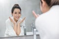 Portrait of asian beautiful woman watch mirror cleansing face in the morning. Royalty Free Stock Photo