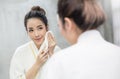 Portrait of asian beautiful woman watch mirror and cleansing face in the morning before shower. Royalty Free Stock Photo